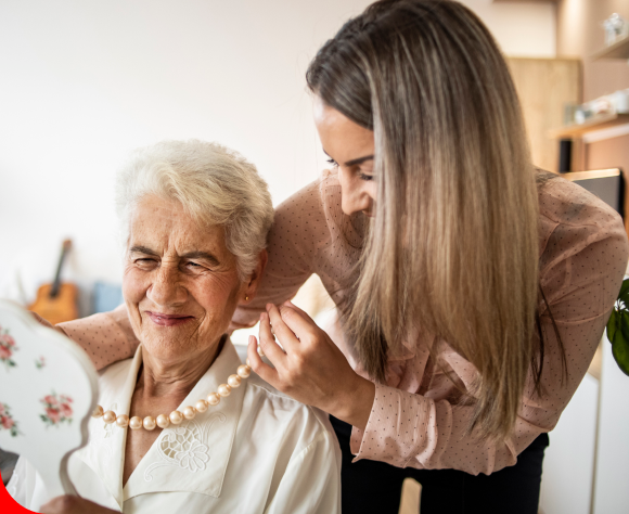 a person touching an older person's neck