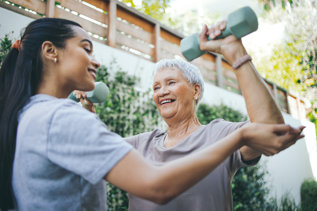 a person lifting weights with an older person
