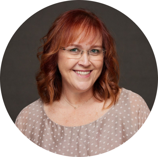 a person with red hair wearing glasses