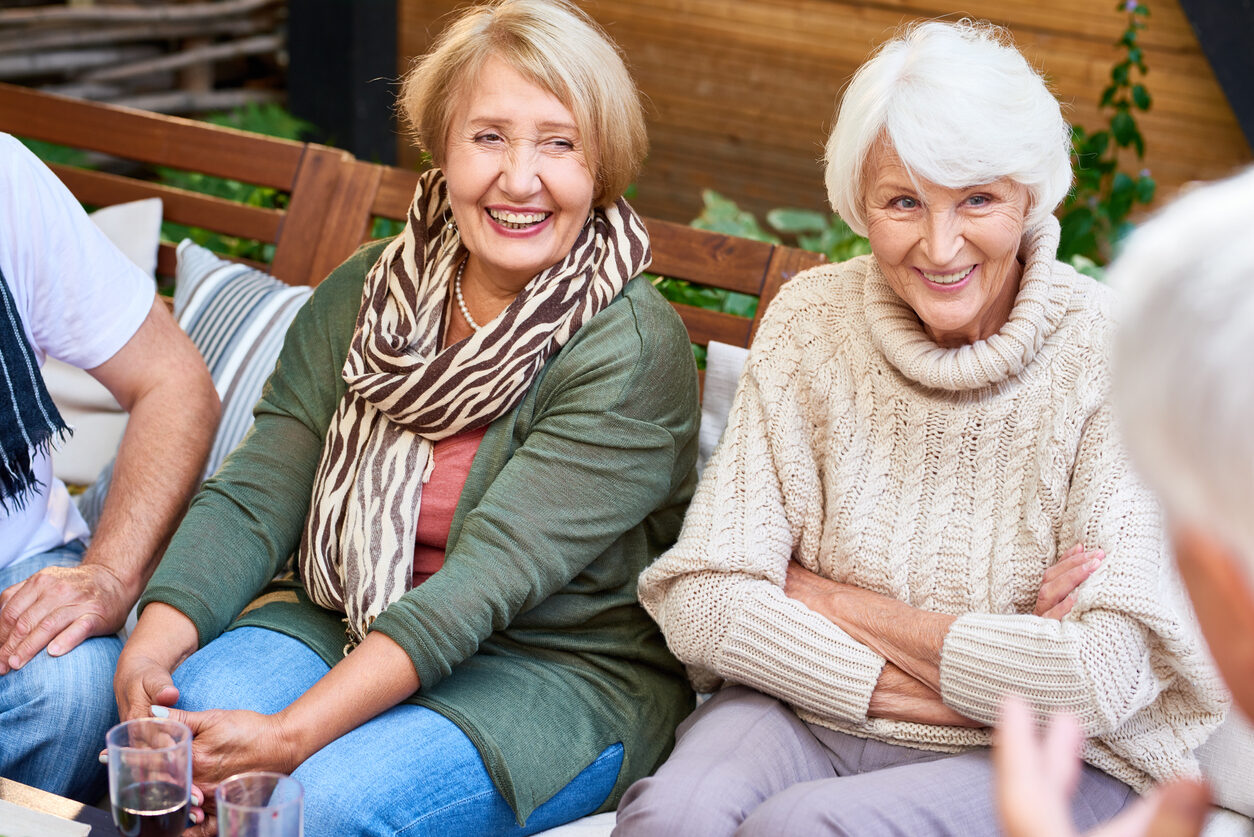 a group of women sitting on a bench