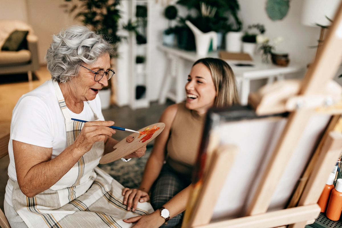 a person painting a picture with a person