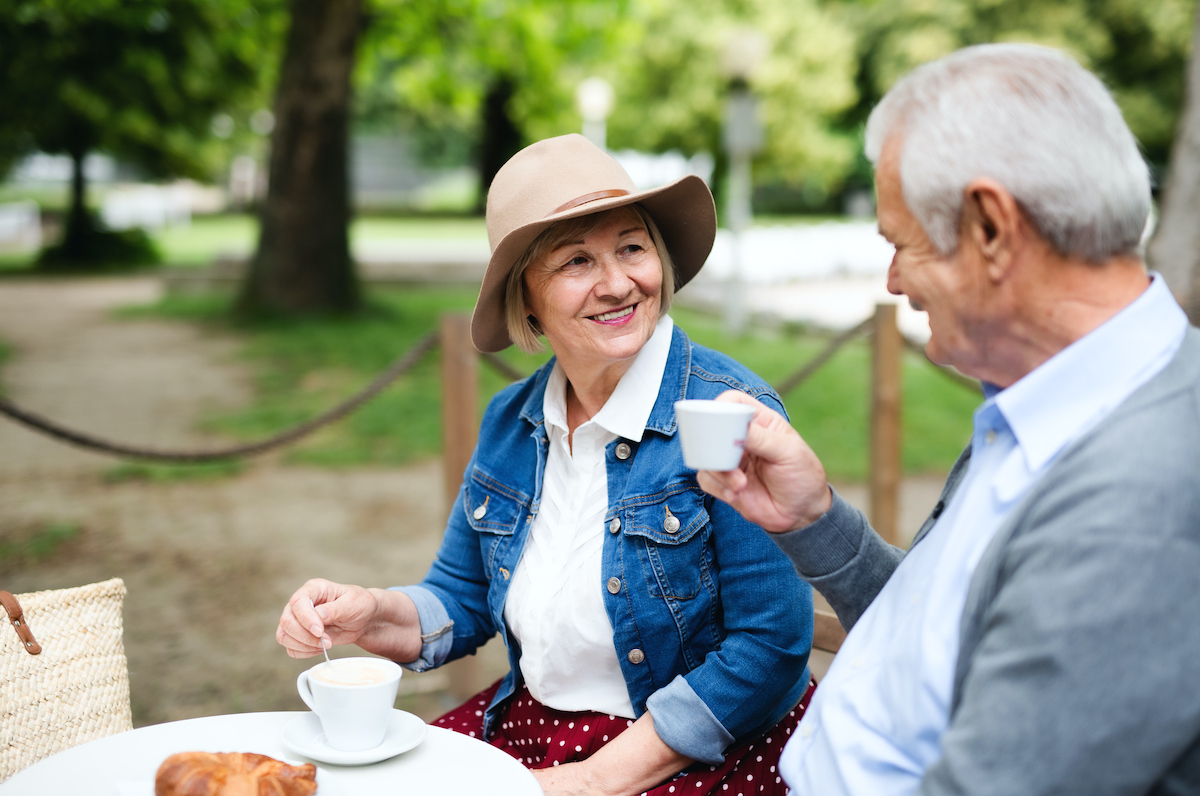 a person and person sitting at a table with food