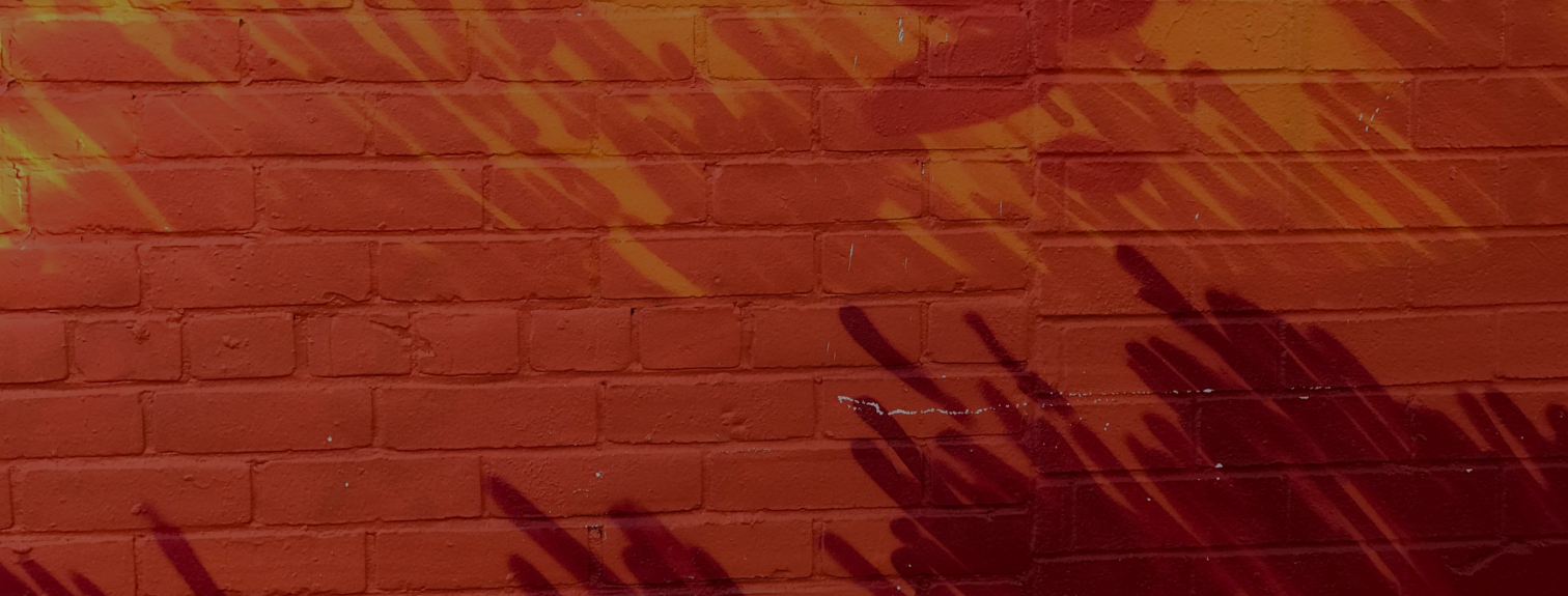 a brick wall with red paint