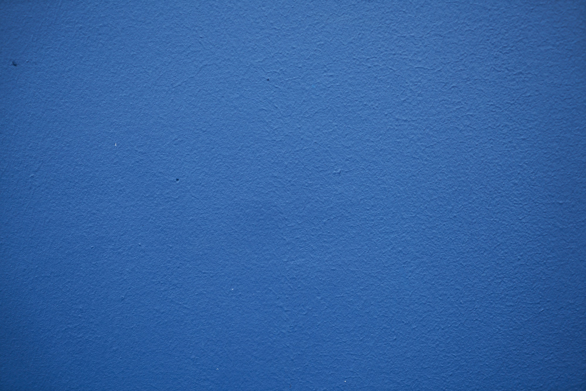 a blue wall with white spots