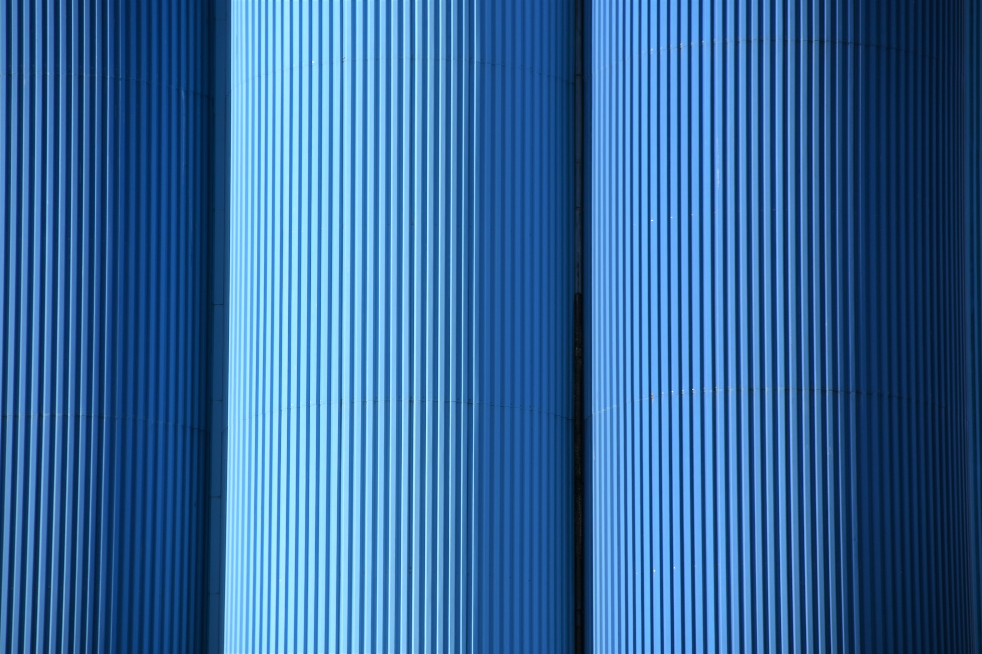 a blue cylindrical structure with vertical lines