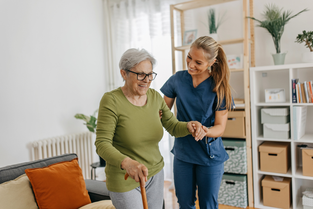 a person holding a cane and smiling