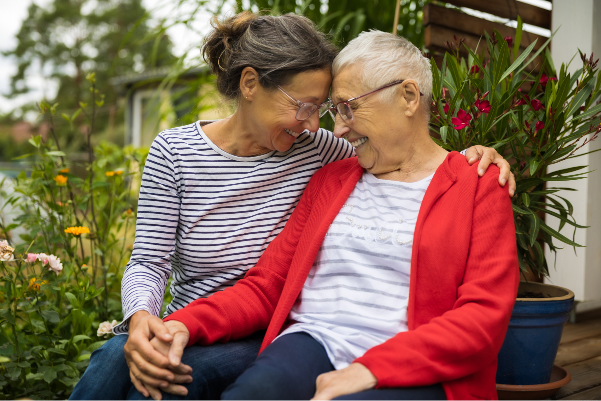 two women sitting on a bench